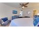 Spacious main bedroom featuring a king bed, ceiling fan, and ensuite bathroom access at 110 Vista Hermosa Cir # 102B, Sarasota, FL 34242