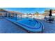 Community pool area with clear blue water, lounge chairs, and a view of the surrounding residences at 110 Vista Hermosa Cir # 102B, Sarasota, FL 34242