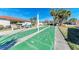 Active shuffleboard court with lush landscaping, offering a recreational space for residents at 110 Vista Hermosa Cir # 102B, Sarasota, FL 34242