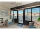 Cozy sunroom with sliding glass doors leading to an outdoor patio and community area at 110 Vista Hermosa Cir # 102B, Sarasota, FL 34242