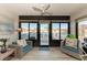 Comfortable sunroom with lounge chairs and sliding glass doors offering access to outdoor amenities at 110 Vista Hermosa Cir # 102B, Sarasota, FL 34242