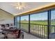 Enclosed lanai featuring wicker seating with a beautiful view of the serene surroundings at 1106 Bird Bay Way # 316, Venice, FL 34285