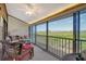 Screened lanai featuring wicker seating with a beautiful view of the lush surroundings at 1106 Bird Bay Way # 316, Venice, FL 34285