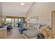Comfortable living room with neutral tones, sliding doors, and a view of the outdoors at 1106 Bird Bay Way # 316, Venice, FL 34285