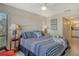Cozy main bedroom with a ceiling fan, neutral walls, and an en-suite bathroom at 1106 Bird Bay Way # 316, Venice, FL 34285