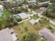 A captivating aerial view showcasing the home, detached garage, and lush backyard with a screened-in pool at 1422 Evangelina Ln, North Port, FL 34286