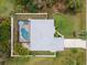 Aerial view of the property highlighting the pool, yard, and roof at 1422 Evangelina Ln, North Port, FL 34286