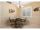 Bright dining room with tile floor, decorative wall art, and a charming chandelier at 1422 Evangelina Ln, North Port, FL 34286