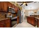 Kitchen with wood cabinets, stainless steel appliances, and granite countertops at 1422 Evangelina Ln, North Port, FL 34286