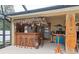 Custom tiki bar with seating and décor for entertaining at 1422 Evangelina Ln, North Port, FL 34286