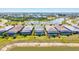 Aerial view showcases the backyard pools of homes overlooking a beautiful lake in a well-planned community at 14724 Ponce De Leon Trl, Port Charlotte, FL 33981