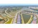 Expansive aerial shot showcases houses lined along a pond, part of a community amid lush greenery and connecting waterways at 14724 Ponce De Leon Trl, Port Charlotte, FL 33981