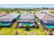 Aerial view featuring luxurious homes with private pools, all overlooking a beautiful lake in a picturesque community at 14724 Ponce De Leon Trl, Port Charlotte, FL 33981