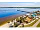 Breathtaking aerial view featuring a fishing pier, sandy beach, swimming pool, tennis court, and community recreation area at 14724 Ponce De Leon Trl, Port Charlotte, FL 33981
