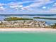 Picturesque aerial scene of a coastal community featuring white sand beaches, turquoise waters, and lush green islands in a sunny environment at 14724 Ponce De Leon Trl, Port Charlotte, FL 33981