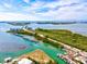 Stunning aerial view showcasing a waterfront property with a scenic bridge and lush green landscapes at 14724 Ponce De Leon Trl, Port Charlotte, FL 33981