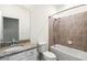 Bathroom with granite countertops, white cabinets, a combined bath and shower, and tile accents at 14724 Ponce De Leon Trl, Port Charlotte, FL 33981