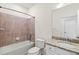 Inviting bathroom featuring granite countertops, white cabinetry, and a bathtub-shower combination at 14724 Ponce De Leon Trl, Port Charlotte, FL 33981