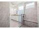 Elegant bathroom with a tiled shower featuring a built-in bench, and a vanity with granite countertops at 14724 Ponce De Leon Trl, Port Charlotte, FL 33981
