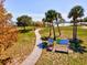 A serene view of Port Charlotte Beach Park with a winding path, lush trees, and signage, inviting visitors to explore at 14724 Ponce De Leon Trl, Port Charlotte, FL 33981