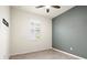 Bedroom featuring tile floors, a gray accent wall, shutters, and a ceiling fan at 14724 Ponce De Leon Trl, Port Charlotte, FL 33981