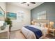 Stylish bedroom with neutral decor, bright walls, shutters, tile floors, and tasteful wall art at 14724 Ponce De Leon Trl, Port Charlotte, FL 33981