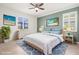 Serene bedroom with coastal decor, plantation shutters, a ceiling fan, and stylish furnishings for a relaxing ambiance at 14724 Ponce De Leon Trl, Port Charlotte, FL 33981