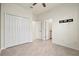 Bedroom featuring tile flooring, a ceiling fan, double doors, and fresh white walls at 14724 Ponce De Leon Trl, Port Charlotte, FL 33981