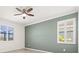 Bright bedroom featuring shuttered windows and a modern ceiling fan at 14724 Ponce De Leon Trl, Port Charlotte, FL 33981