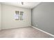 Well-lit bedroom with tile flooring, a gray accent wall, and a window with plantation shutters at 14724 Ponce De Leon Trl, Port Charlotte, FL 33981