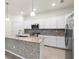 Well-lit kitchen with granite countertops, stainless steel appliances, and a stylish mosaic backsplash at 14724 Ponce De Leon Trl, Port Charlotte, FL 33981