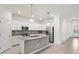 Modern kitchen with stainless steel appliances, granite countertops and hexagonal backsplash at 14724 Ponce De Leon Trl, Port Charlotte, FL 33981