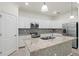Bright kitchen featuring granite countertops, stainless appliances, and mosaic backsplash at 14724 Ponce De Leon Trl, Port Charlotte, FL 33981