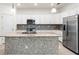 Bright kitchen featuring granite countertops, stainless appliances, and mosaic backsplash at 14724 Ponce De Leon Trl, Port Charlotte, FL 33981
