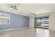 Bright living room featuring tile floors, ceiling fans and patio door at 14724 Ponce De Leon Trl, Port Charlotte, FL 33981