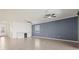 Spacious living room with neutral tile flooring, modern ceiling fans, and a built-in bar area beneath a shuttered window at 14724 Ponce De Leon Trl, Port Charlotte, FL 33981