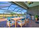 Covered patio with seating area, outdoor grill, and view of the lake, perfect for entertaining at 14724 Ponce De Leon Trl, Port Charlotte, FL 33981