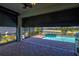 Covered outdoor pool area with motorized shades for privacy, offering a relaxing space with scenic views at 14724 Ponce De Leon Trl, Port Charlotte, FL 33981