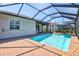 Backyard pool featuring a screened-in enclosure and covered patio with access to the home's interior at 14724 Ponce De Leon Trl, Port Charlotte, FL 33981