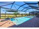 Screened-in pool area with sunshade offering a serene space for relaxation and recreation at 14724 Ponce De Leon Trl, Port Charlotte, FL 33981