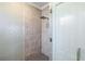 Modern bathroom featuring a tiled shower with a glass door and a rainfall shower head at 14724 Ponce De Leon Trl, Port Charlotte, FL 33981