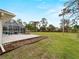 Expansive backyard featuring a screened-in pool area and mature landscaping, perfect for outdoor living at 1611 Thomas St, Englewood, FL 34223