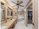 Large bathroom with double sinks, a soaking tub, and a walk-in closet at 1611 Thomas St, Englewood, FL 34223