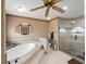 Elegant bathroom featuring a modern soaking tub and glass-enclosed shower for a spa-like experience at 1611 Thomas St, Englewood, FL 34223