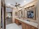 Spacious bathroom with dual sinks, granite countertops, and ample storage space at 1611 Thomas St, Englewood, FL 34223