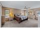 Spacious bedroom featuring neutral decor, a ceiling fan, and ample natural light from multiple windows at 1611 Thomas St, Englewood, FL 34223