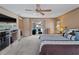 Bright bedroom featuring a ceiling fan, with sliding glass doors leading to the backyard patio at 1611 Thomas St, Englewood, FL 34223