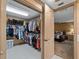 Walk-in closet with plentiful storage space for clothes and shoes, adjoins the primary bedroom at 1611 Thomas St, Englewood, FL 34223