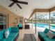 Wide view of screened-in patio with outdoor furniture and view of pool and fenced backyard at 1611 Thomas St, Englewood, FL 34223