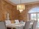 Elegant dining room with chandelier, neutral colors, and natural light through the arch window at 1611 Thomas St, Englewood, FL 34223